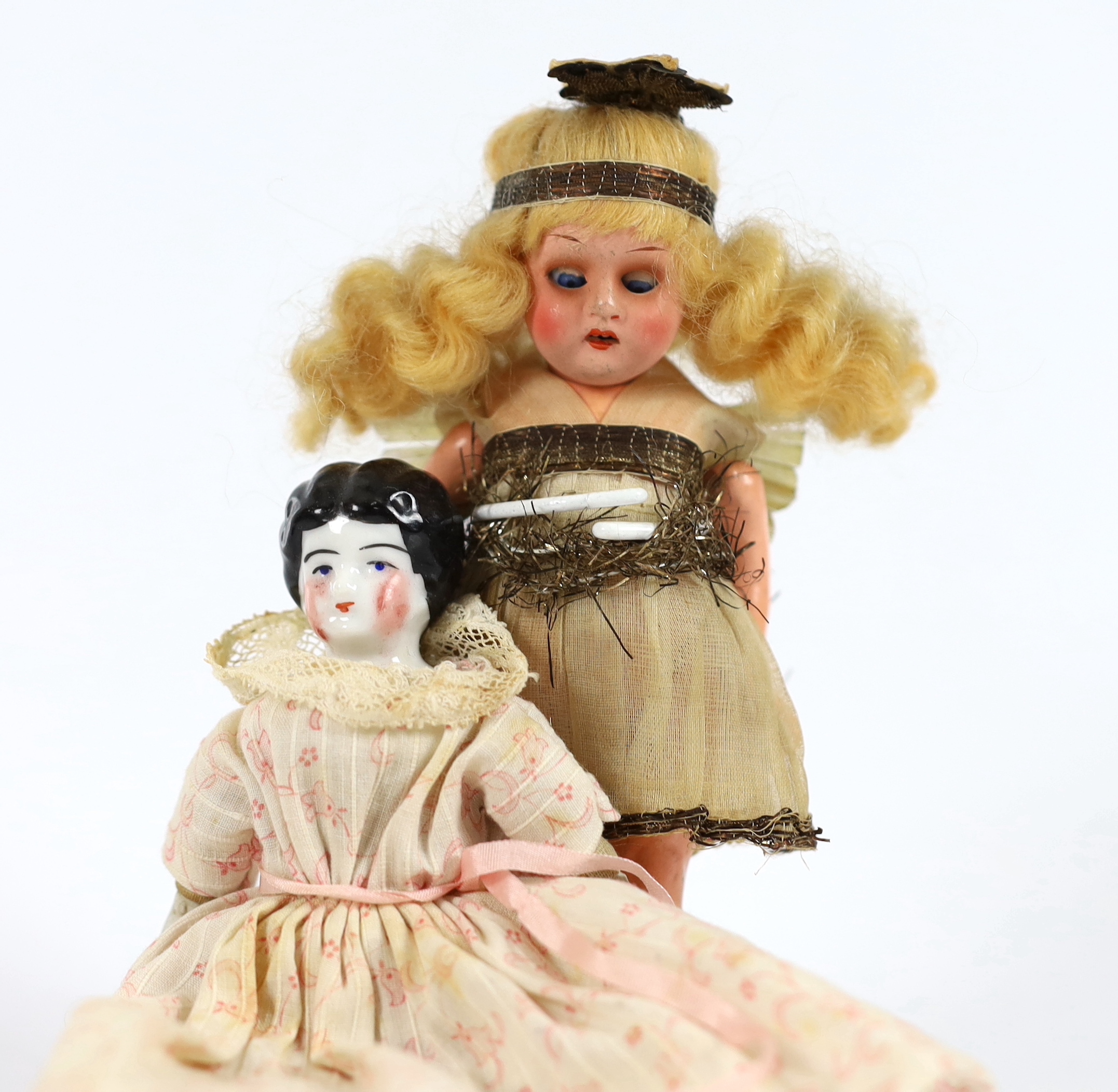 A composition fairy doll, c.1920m 15cm, with a china headed doll on soft body with bisque boots, c.1870, 15cm